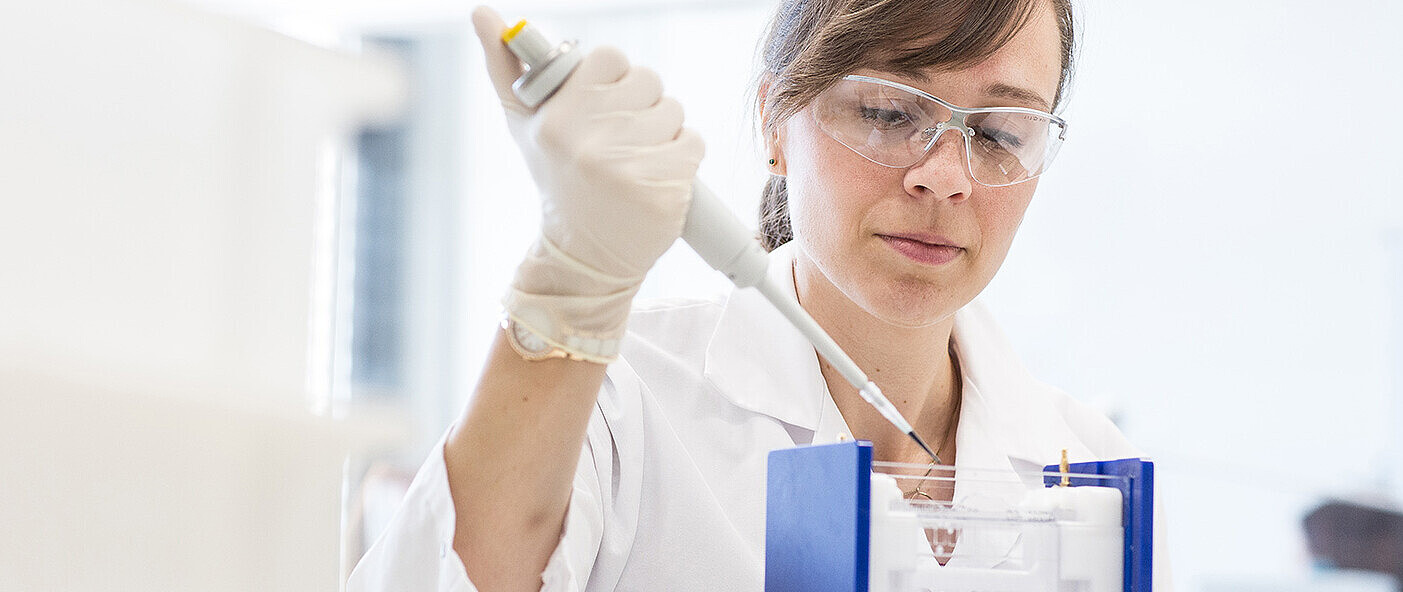 Lab employee with pipette